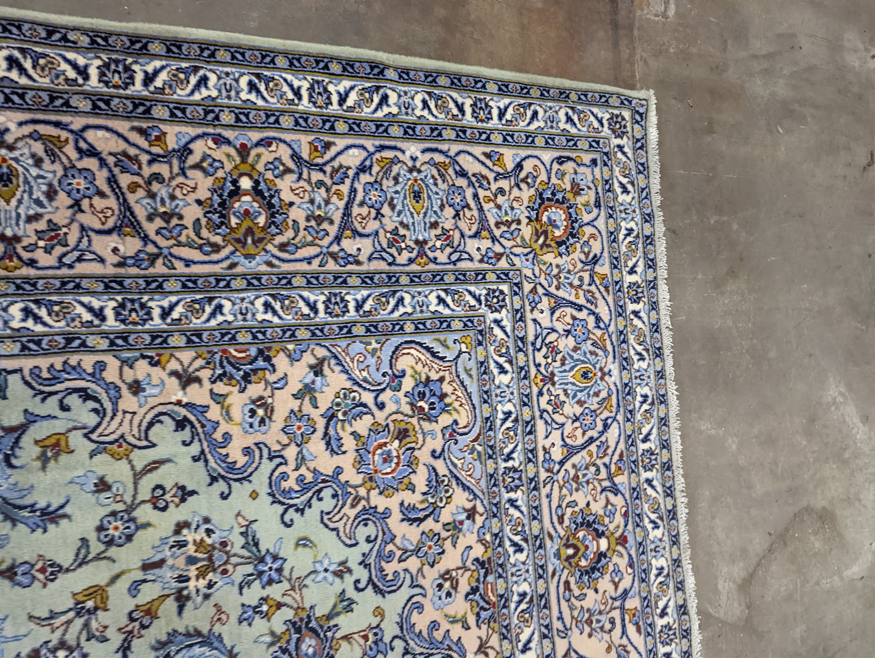A Kashan pale green ground carpet, 410 x 296cm
